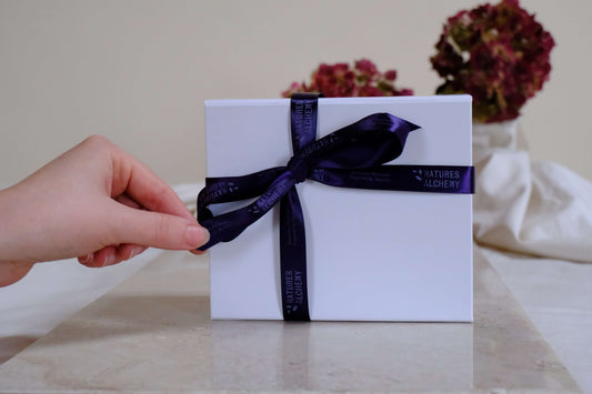 Natures Alchemy Discovery Box wrapped in white gift box with branded ribbon